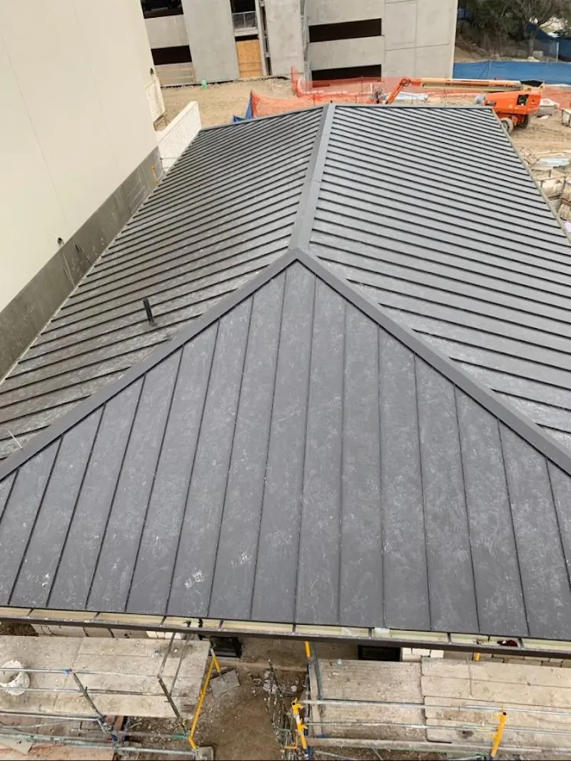 Commercial metal roof construction with crane equipment in Florence-Graham