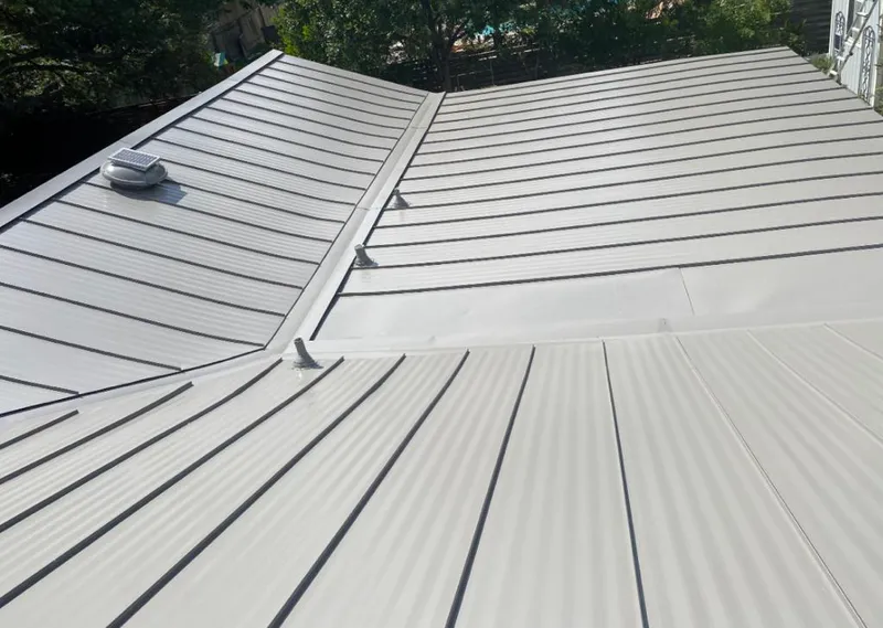 Solar attic fan installed on a metal roof for Roof Ventilation in Florence-Graham